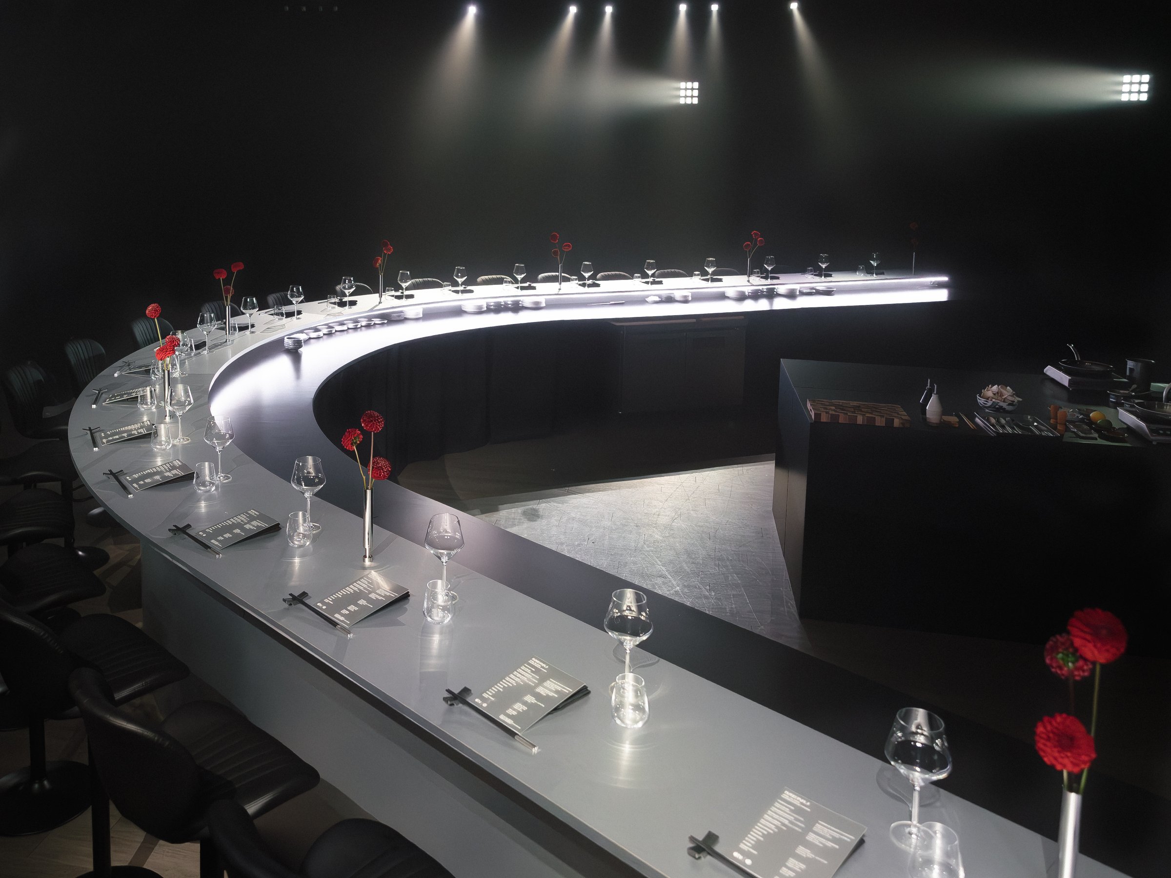 Silhouettes of guests seated at the omakase counter at the Apple TV x Beats Miami Grand Prix dinner, photographed by Alicia Valdez