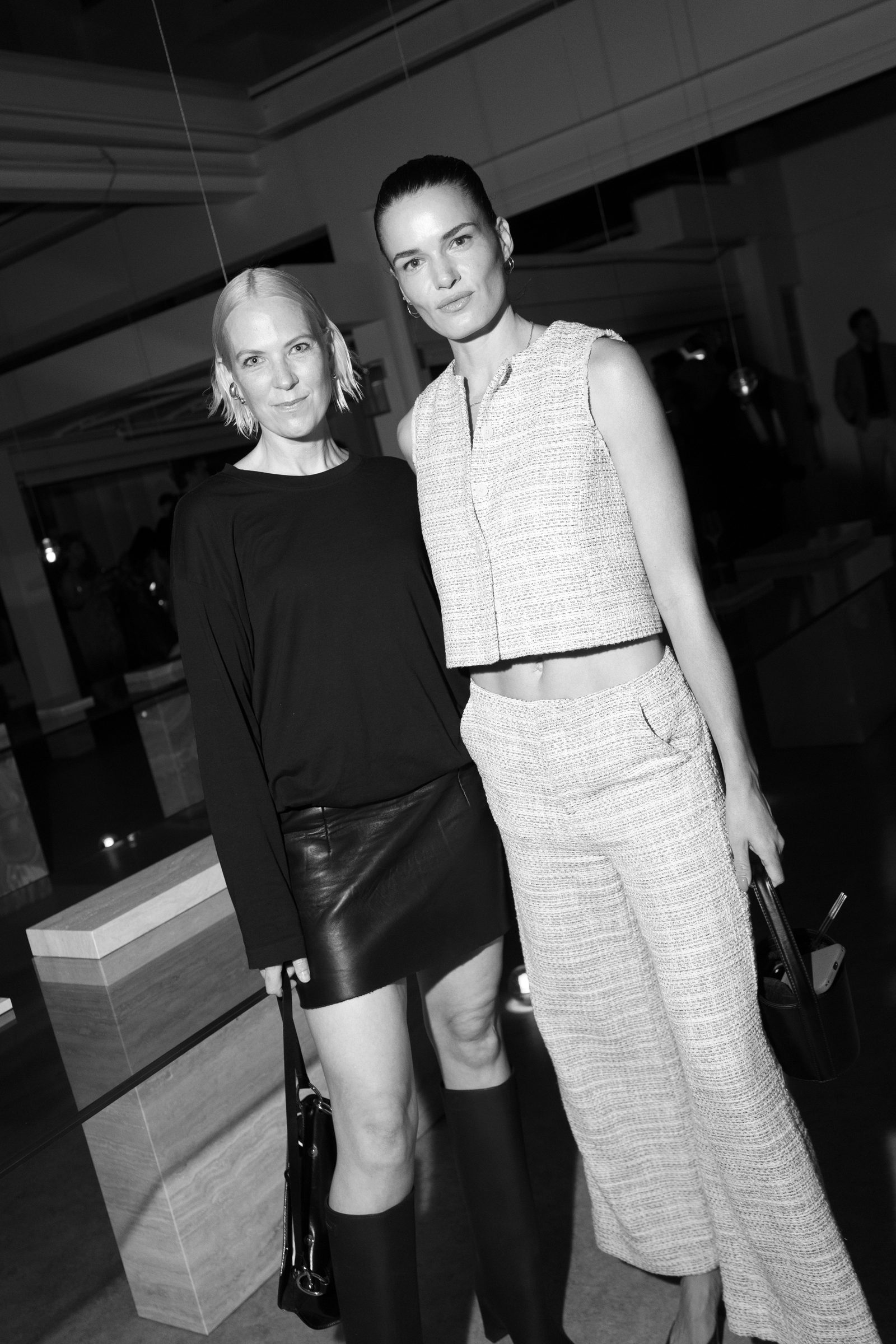 Two guests photographed in black and white at the We Are Ona Miami Art Week dinner during Art Basel 2025, by Alicia Valdez